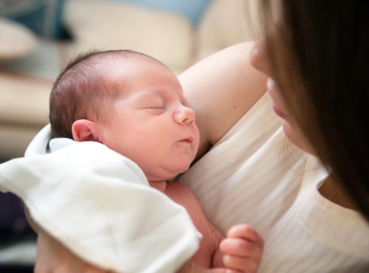 A newborn sleeping peacefully on a parent's chest